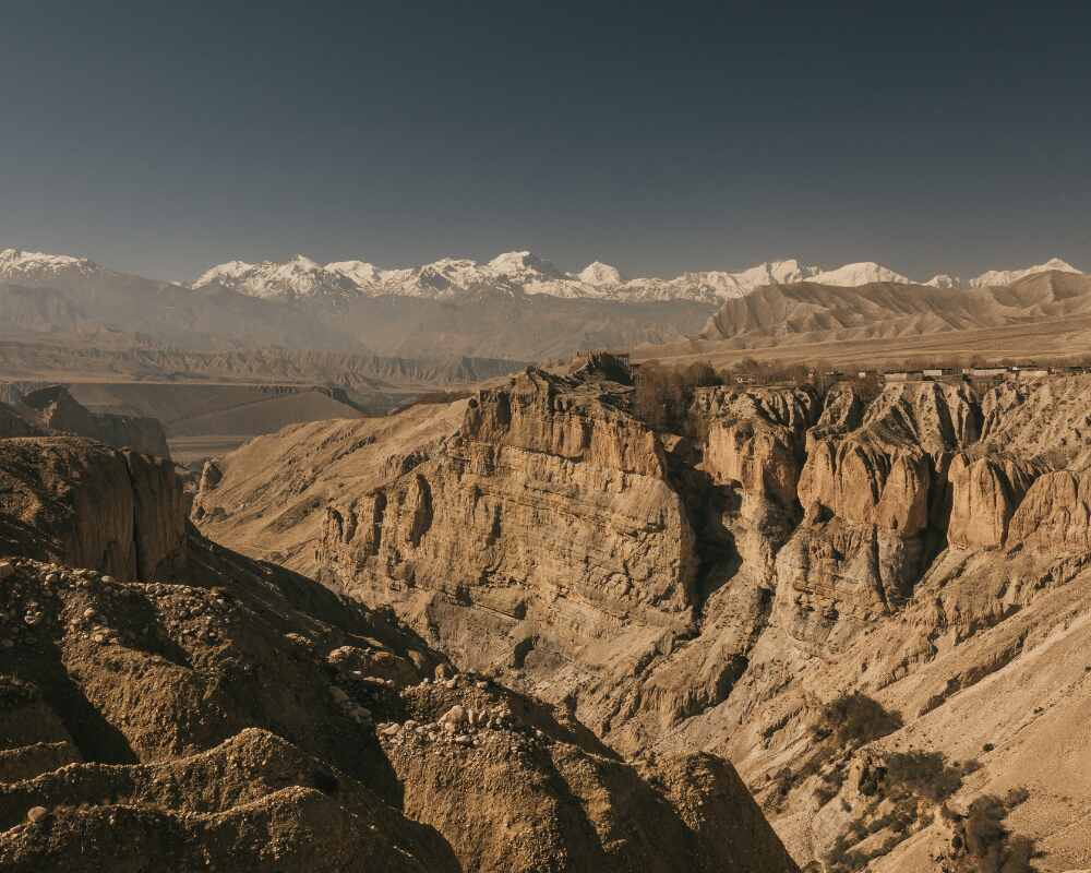 misty, cloud-wrapped shot of Upper Mustang's dry, dramatic cliffs