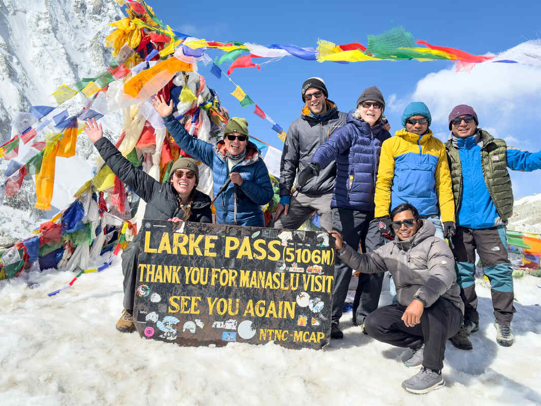 Trekker celebrating at Larkya La summit Manaslu Circuit