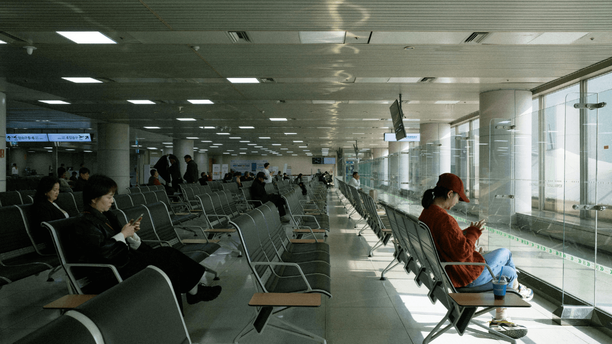 Traveler using eSIM on smartphone at airpor